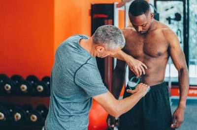 coach measuring clients body fat with caliper royalty free image 1708624085